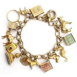  9ct gold fancy link charm bracelet with 22ct gold ring and 9ct gold charms including camera, first aid box, seal etc  