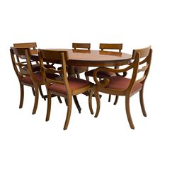 Regency design yew wood dining table, oval cross-banded top with reeded edge, raised on turned pedestal with reeded sabre supports terminating in brass hairy paw feet and castors (W138cm D100cm H75cm); and Rackstraw - set six (4+2) Regency design dining chairs with red drop-in seats (W50cm H86cm)