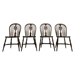 Set four oak Windsor chairs, hoop and stick back with pierced splat, dished seats on turned supports with crinoline stretcher