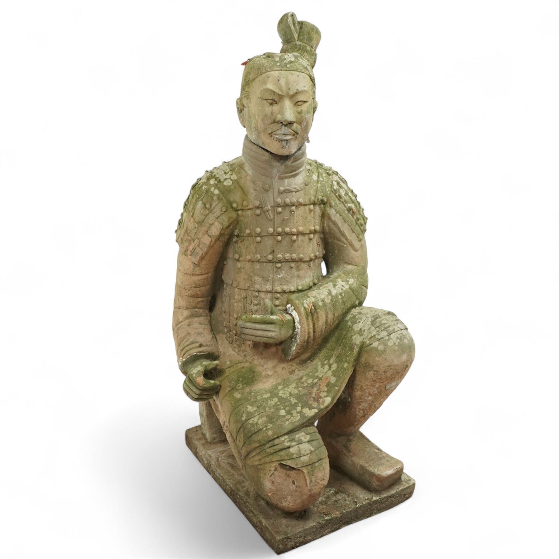 Two near life-size terracotta warrior figures, modelled in the style of the Qin dynasty soldiers, each kneeling with one arm raised, wearing detailed armour and tunics, one example partially damaged and lacking sections