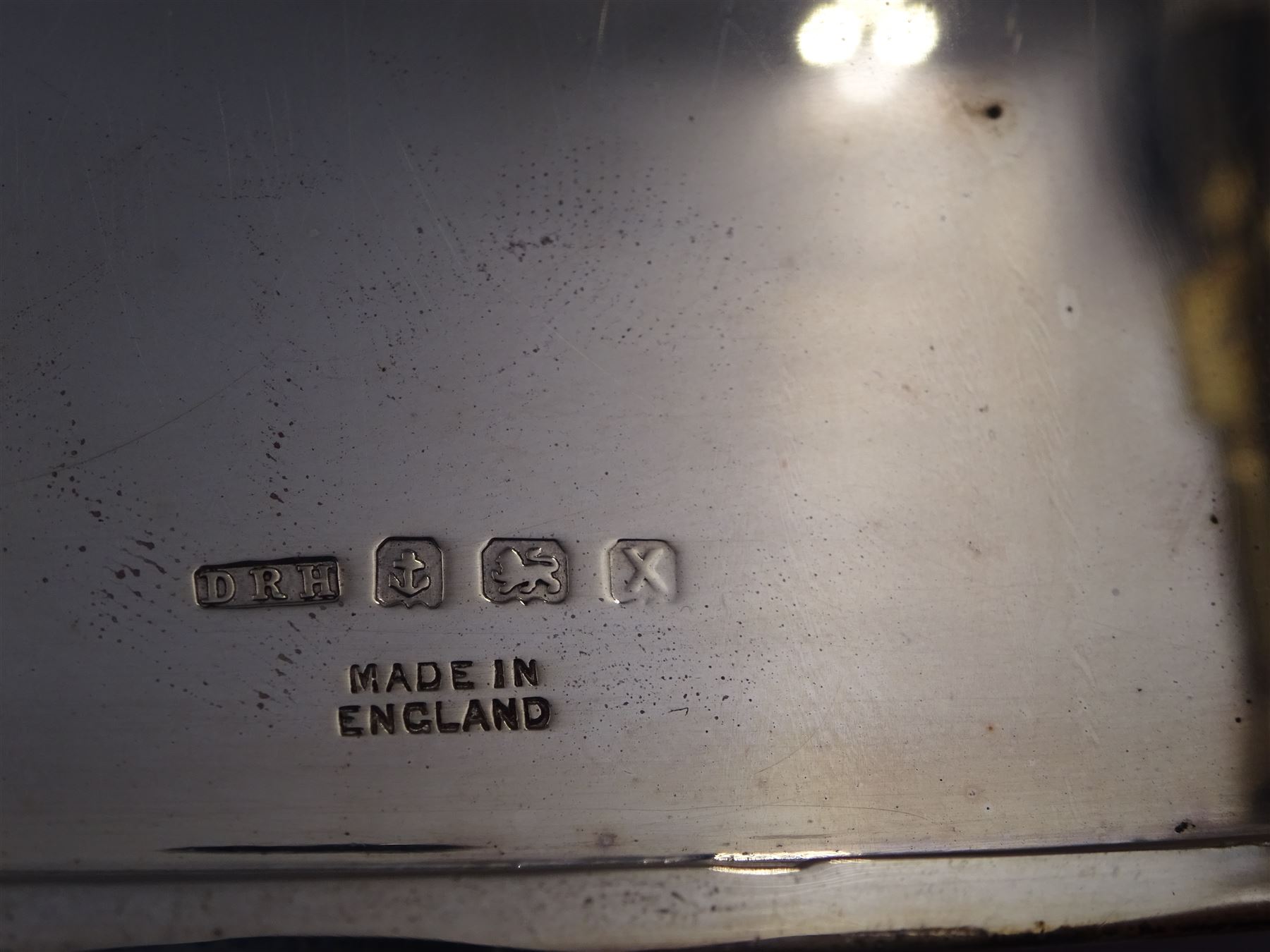 Mid 20th century silver cigarette case, of rectangular form with geometric engraved decoration, hallmarked Dudley Russell Howitt, Birmingham 1947, H8.5cm