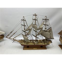 Eight model ships or boats including fishing boat with fish, nets and buoyancy aid, two mast sailing ship complete with cannons, two mast yacht with detailed rigging and life boat etc, the largest L72cm, H60cm