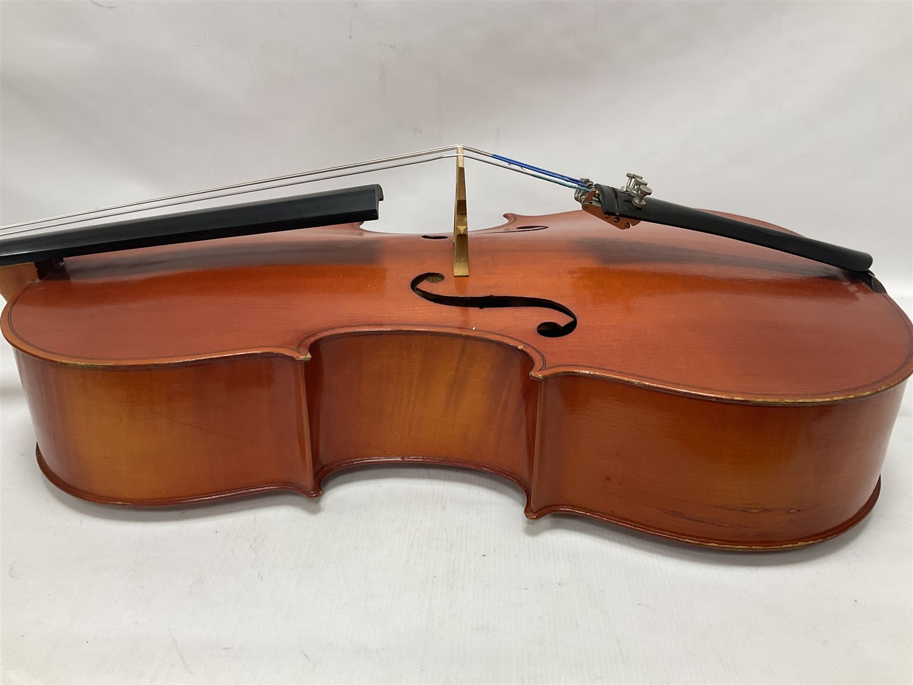 3/4 size cello with soft case, 69cm back length, 114cm full length, with bridge, ebonised tail piece and fingerboard.