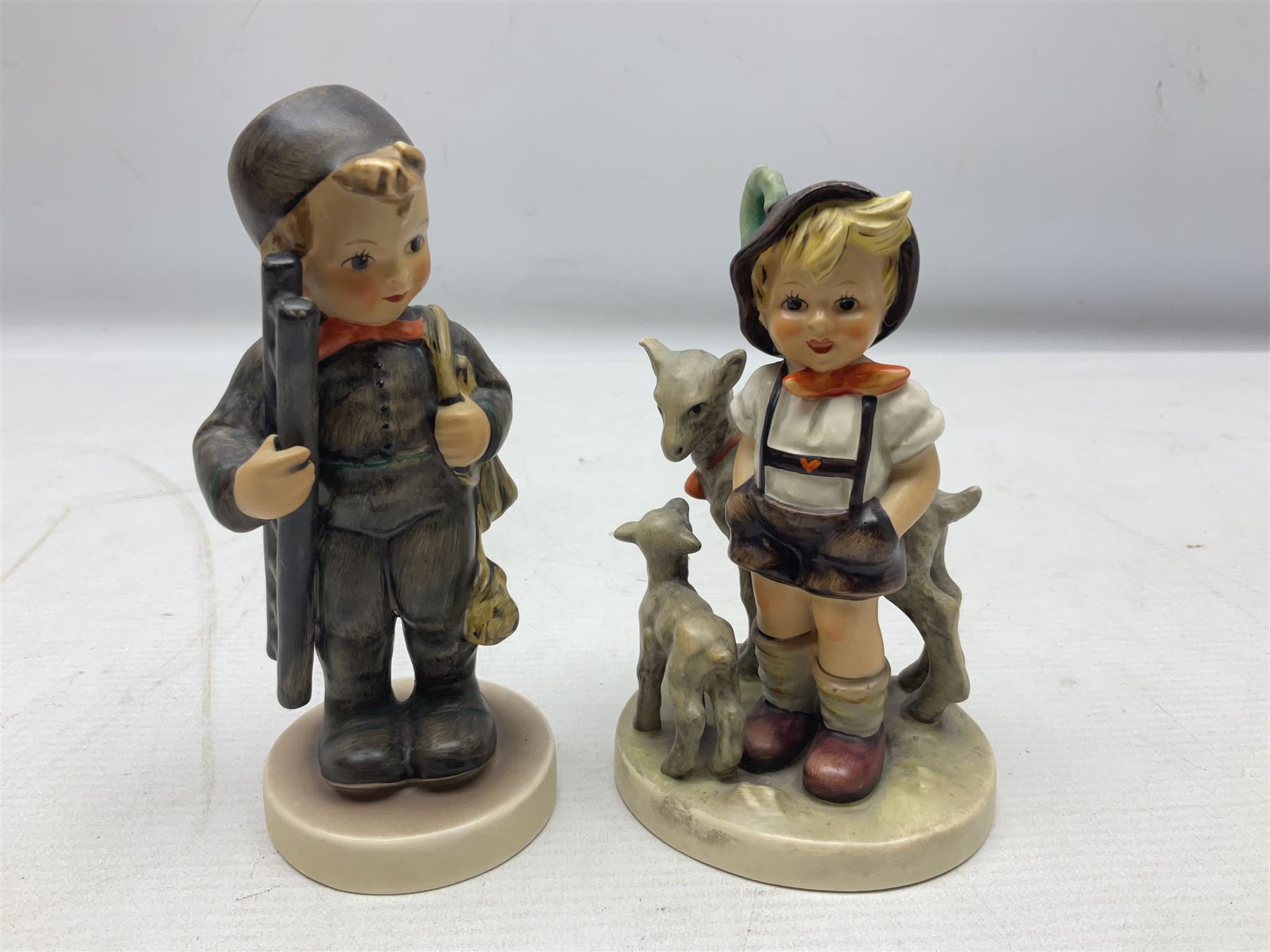 Seven Goebel Hummel figures, comprising Chimney Sweep 12/I, Apple Tree Girl 14/I, Apple Tree Boy,  Little Goat Herder 200/I, Surprise 94 3/0, Signs of Spring 203/20 and Wayside Harmony 111/30, tallest H15cm