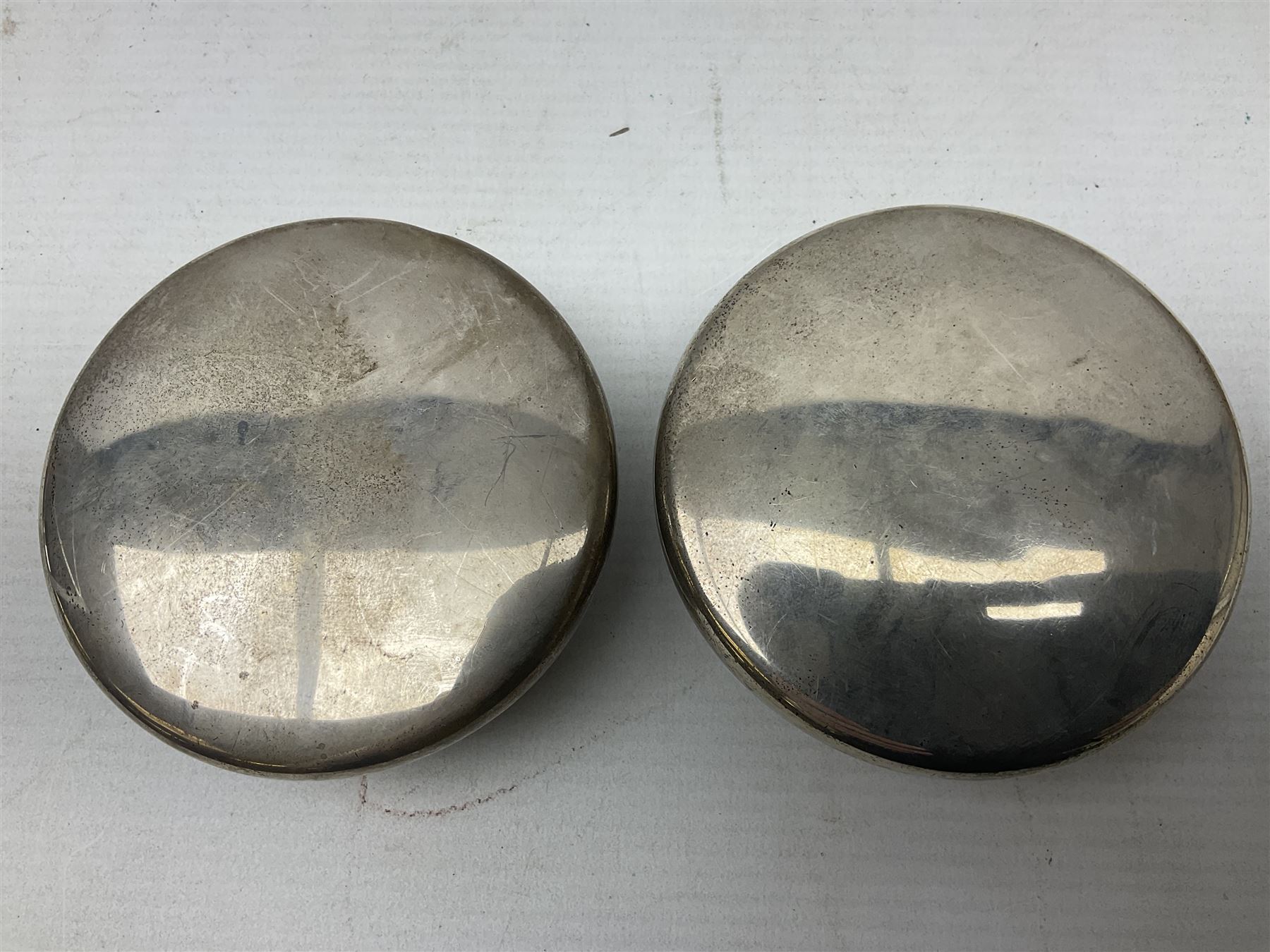 Pair of early 20th century glass dressing table jars, or circular facet cut form, with silver covers, hallmarked London, probably 1912