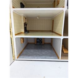 1:24 scale four-storey tudor-style dolls house, with black and white exterior, balcony garden, glazed panelled windows and wooden shingle roof, with decorated interior and wired fireplaces and lighting, H65cm, W58cm, D31cm, 