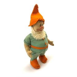 Chad Valley pressed felt figure of the Disney Snow White dwarf 'Doc' with painted facial features, standing wearing a green linen suit with orange hat, belt, buttons and shoes H13