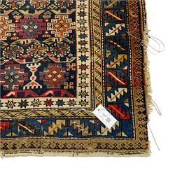 Small Caucasian rug or wall hanging, the indigo ground field decorated with geometric Gul motifs within multiple bands of geometric motifs