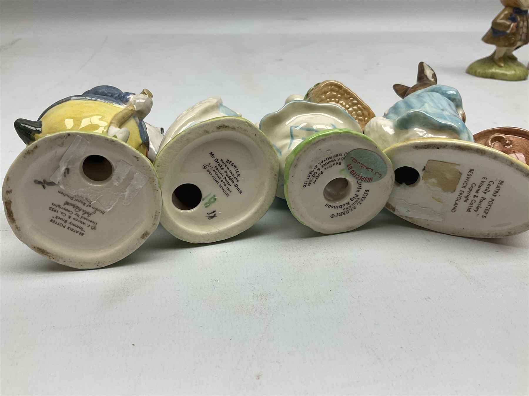 Six Beswick Beatrix Potter figures, comprising Miss Moppet, Tommy Brock, Peter Rabbit, Cecily Parsley, Mr Drake Puddle-Duck, Amiable Guinea Pig, together with four Royal Albert figures, Hunca Munca, Lady Mouse made a curtsy, Little Pig Robinson and Mr McGregor, all with printed mark beneath  (10)