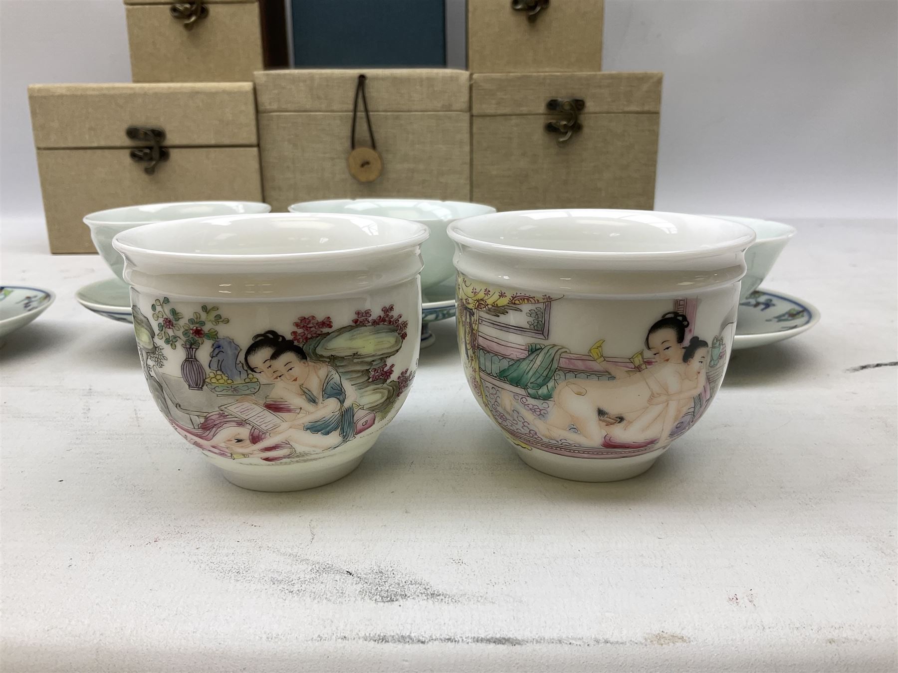 Two Chinese Yixing teapots, Chinese tea bowl hand painted with figures reading, another tea bowl with with underglaze floral panel and another tea bowl with saucer and lid, together with other teacups etc all boxed and with character marks