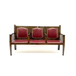 Early 20th century carved oak hall seat, upholstered in studded red leather, tapering supports