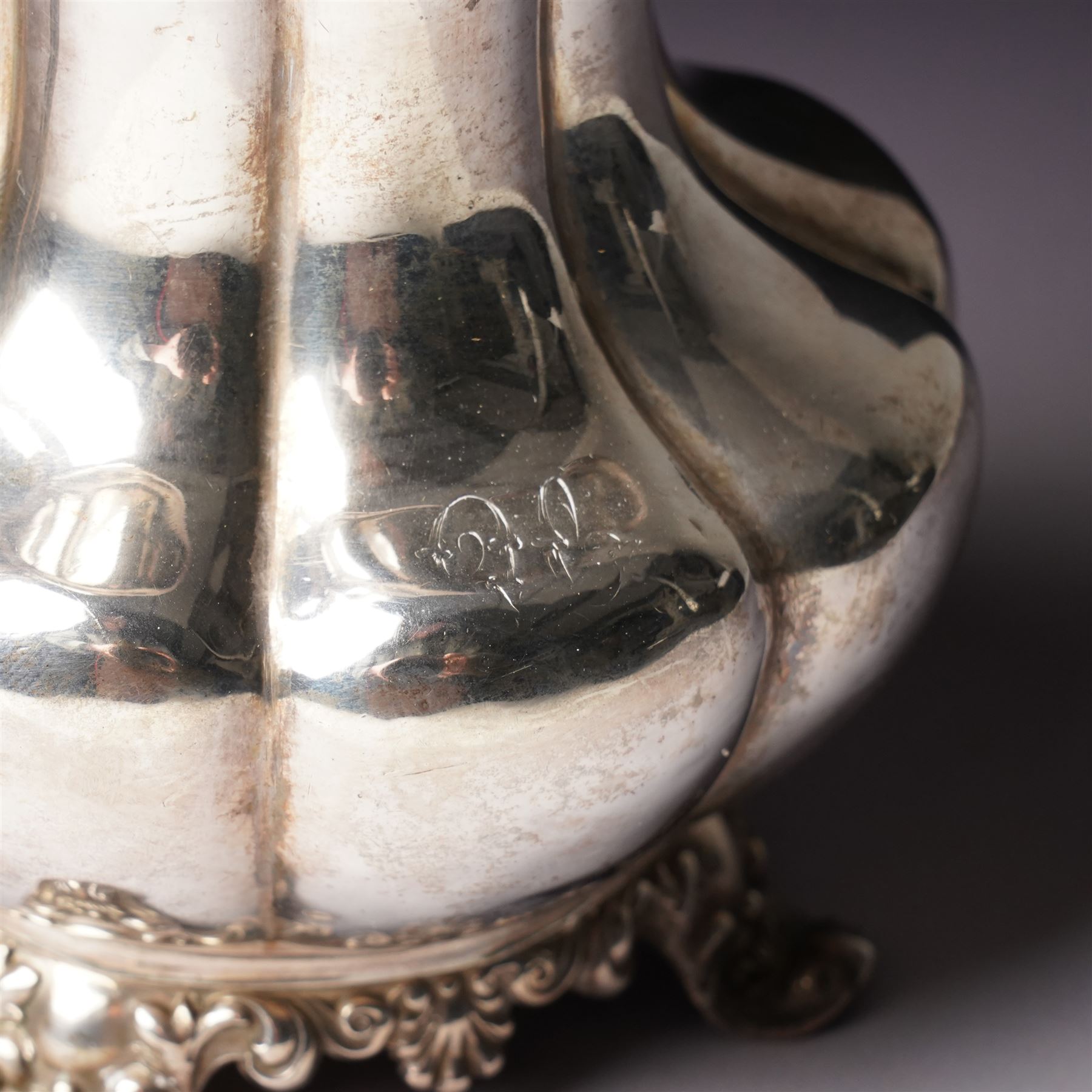 Victorian silver cream jug of panel sided baluster form with crimped rimand scroll handle on shaped supports London 1840 Maker Charles Gordon  