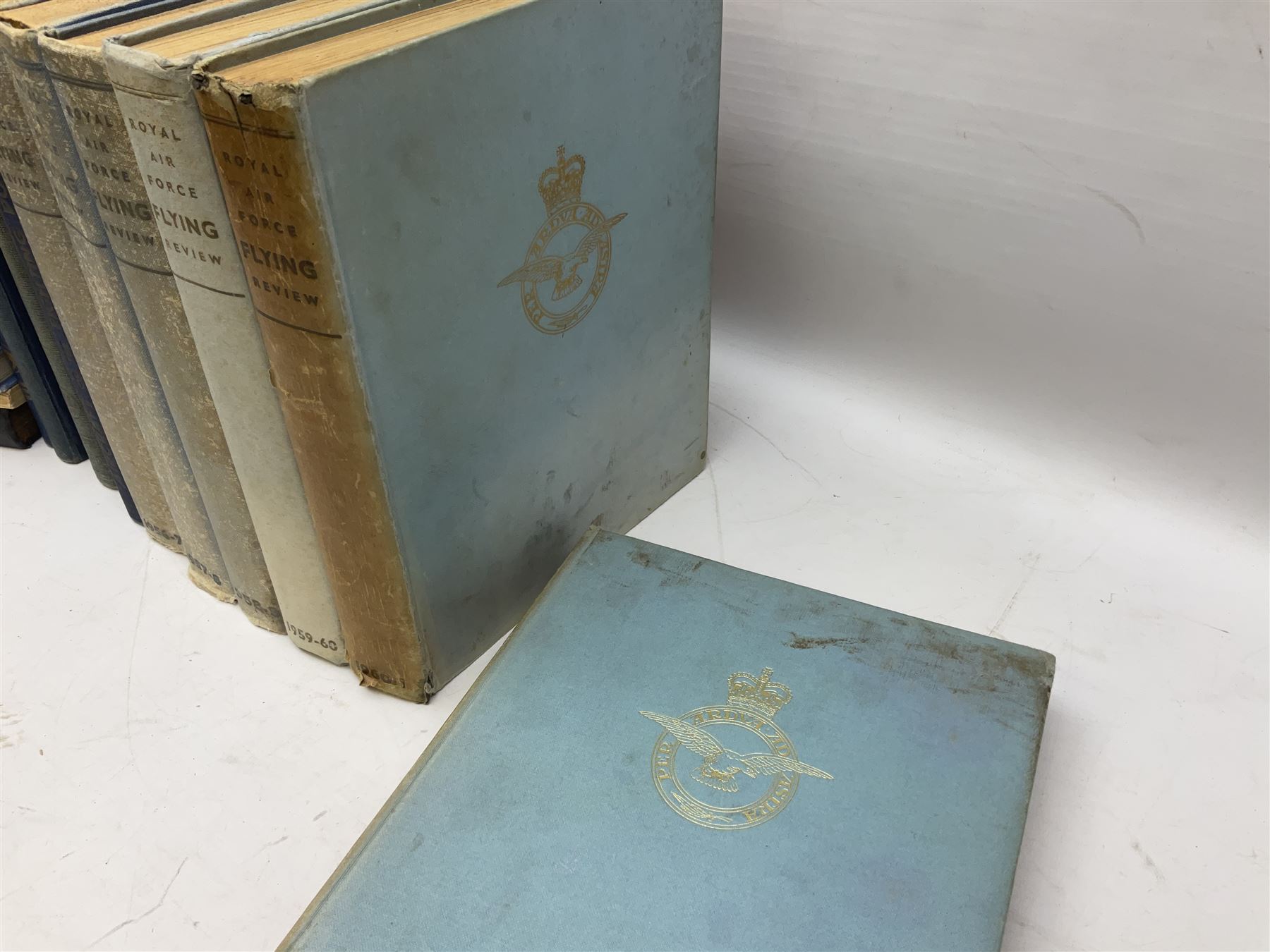 Aircraft of the Fighting Powers. Five volumes. 1940-44 including two copies of volume three; Royal Air Force Flying Review. Six volumes. 1956-63. Uniformly bound in blue cloth with gilt RAF crest to front covers; and ten other books of aircraft and aeronautica interest.