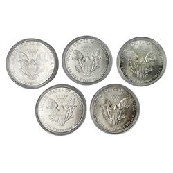 Five United States of America 1oz fine silver one dollar coins, dated 1986, 1987, 1988, 1989 and 1990