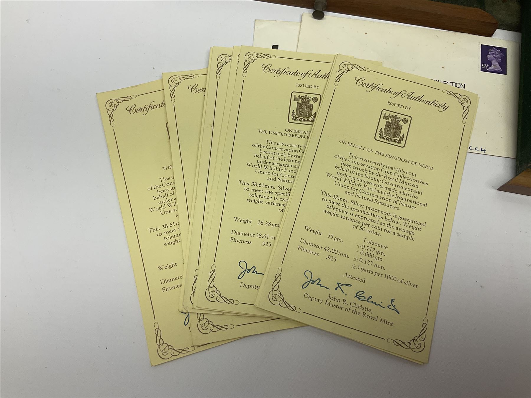 The Royal Mint 'Conservation Coin Collection' formed of twenty-four silver proof coins, housed in the wooden display case, with information booklet