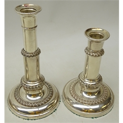  Set of four early 20th century silver-plated telescopic table candlesticks, shaped sconces on plain columns and stepped circular bases with gadrooned detail, stamped 252, H20.5cm max (4)  
