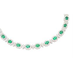 18ct white gold emerald and diamond necklace, fifteen oval cut emeralds, each surrounded by twelve round brilliant cut diamonds and spaced by a further four diamonds, to a fancy openwork oval and bead link necklace, stamped, total emerald weight approx 3.30 carat, total diamond weight approx 2.45 carat