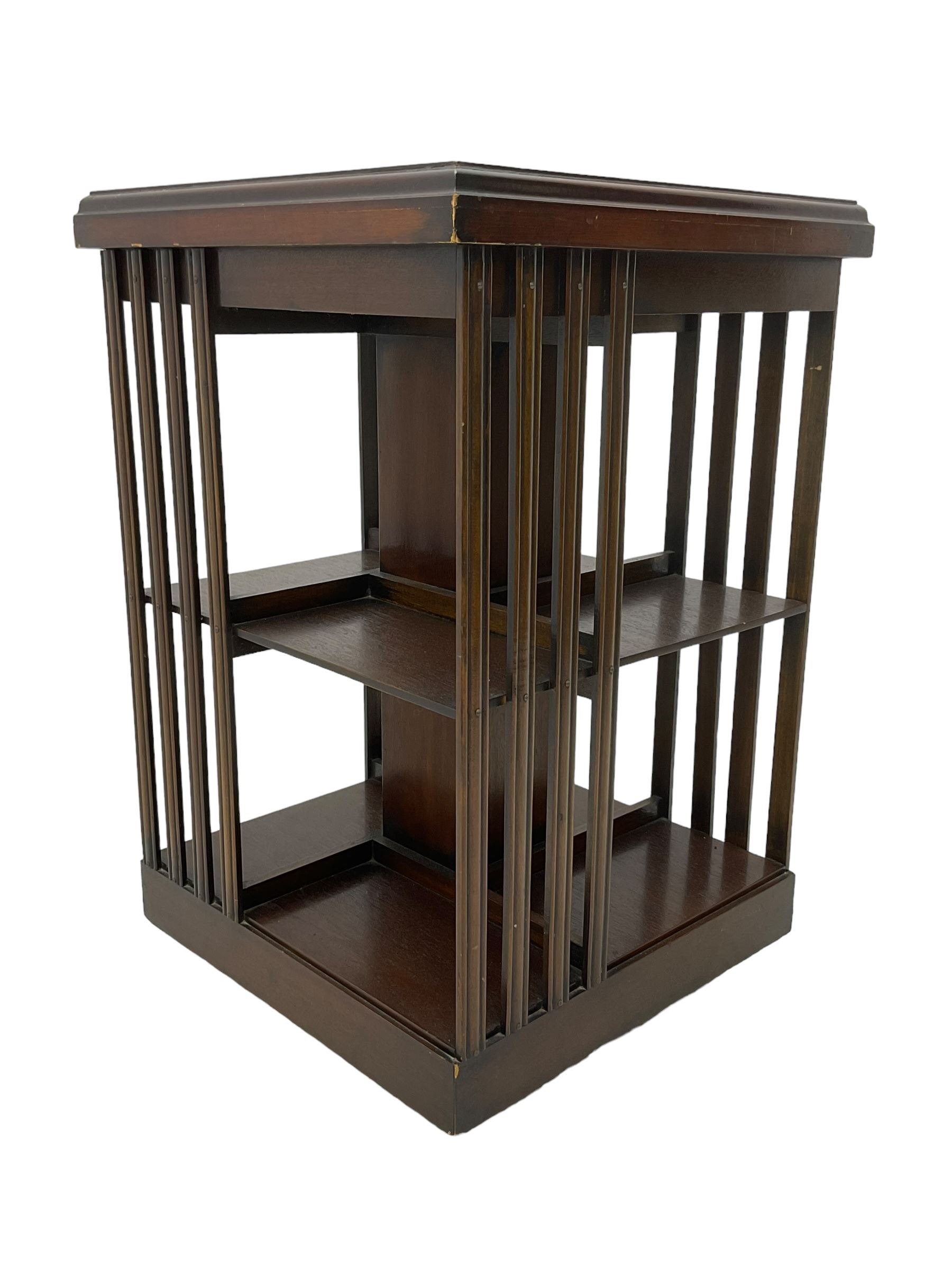 Edwardian revival inlaid mahogany revolving bookcase, square form with moulded top inlaid with central fan motif, two-tiers with moulded upright rails, on castors 