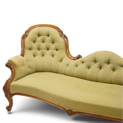 Victorian mahogany framed double ended chaise longue, serpentine button upholstered back with raised scrolled ends, padded arms and stuff-over seat upholstered in green fabric, carved showframe with foliate terminals and scroll supports, on short cabriole legs with brass castors