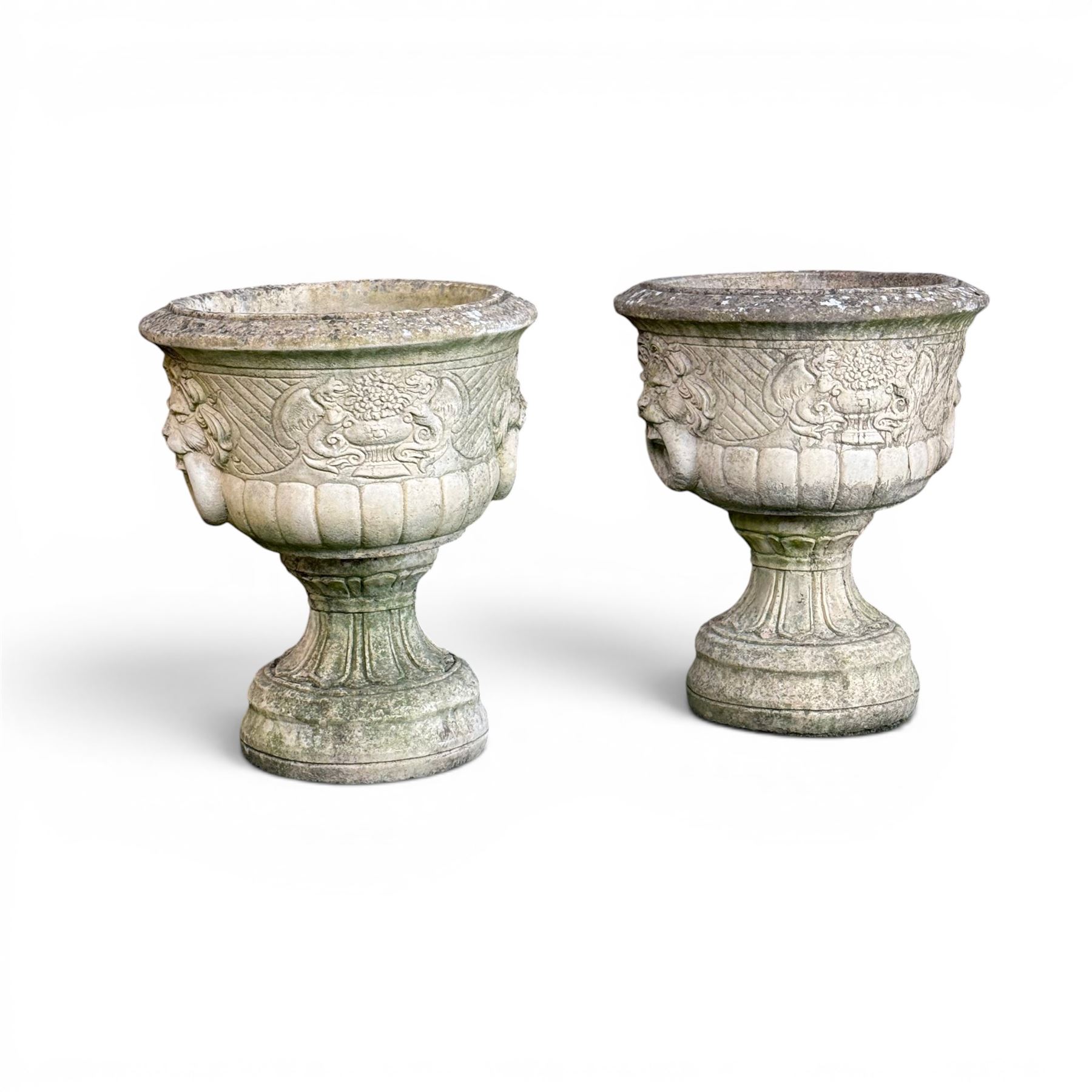 Pair of classic design cast stone garden urns, circular bowl detailed with lion mask loop handles