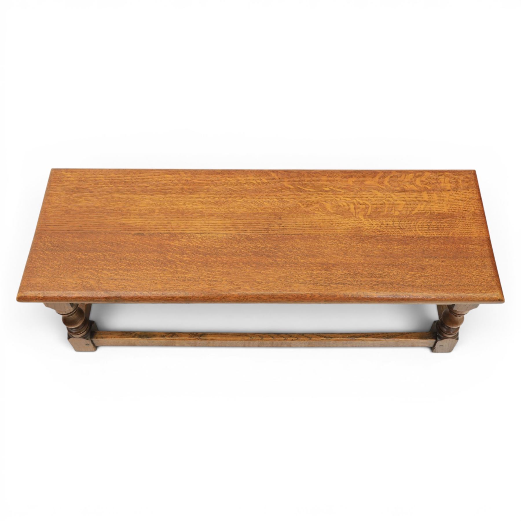 17th century style oak long joint stool, rectangular top with moulded edges, raised on turned supports united by stretchers
