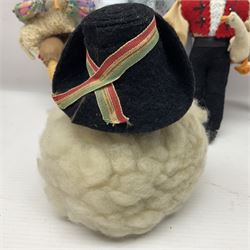 Anna Meszaros Hungary - five hand made needlework figurines including goose girl with stick H20cm; shepherdess in a sitting pose playing a penny whistle with a lamb on her knee; young girl holding a flowerpot; and two others (5)  Auctioneer's Note: Anna Meszaros came to England from her native Hungary in 1959 to marry an English businessman she met while demonstrating her art at the 1958 Brussels Exhibition. Shortly before she left for England she was awarded the title of Folk Artist Master by the Hungarian Government. Anna was a gifted painter of mainly portraits and sculptress before starting to make her figurines which are completely hand made and unique, each with a character and expression of its own. The hands, feet and face are sculptured by layering the material and pulling the features into place with needle and thread. She died in Hull in 1998.