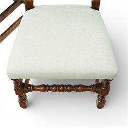 Country House oak high back dining chairs, set of ten comprising eight side chairs and two carvers, each with arched top rail flanked by turned finials over a central fielded panel back, with overstuffed seats upholstered in pale fabric, raised on turned front supports united by stretchers