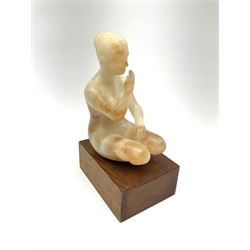 Ann Baxter (British b. 1969): Alabaster figure of a seated lady on rectangular wooden plinth, H22cm overall 