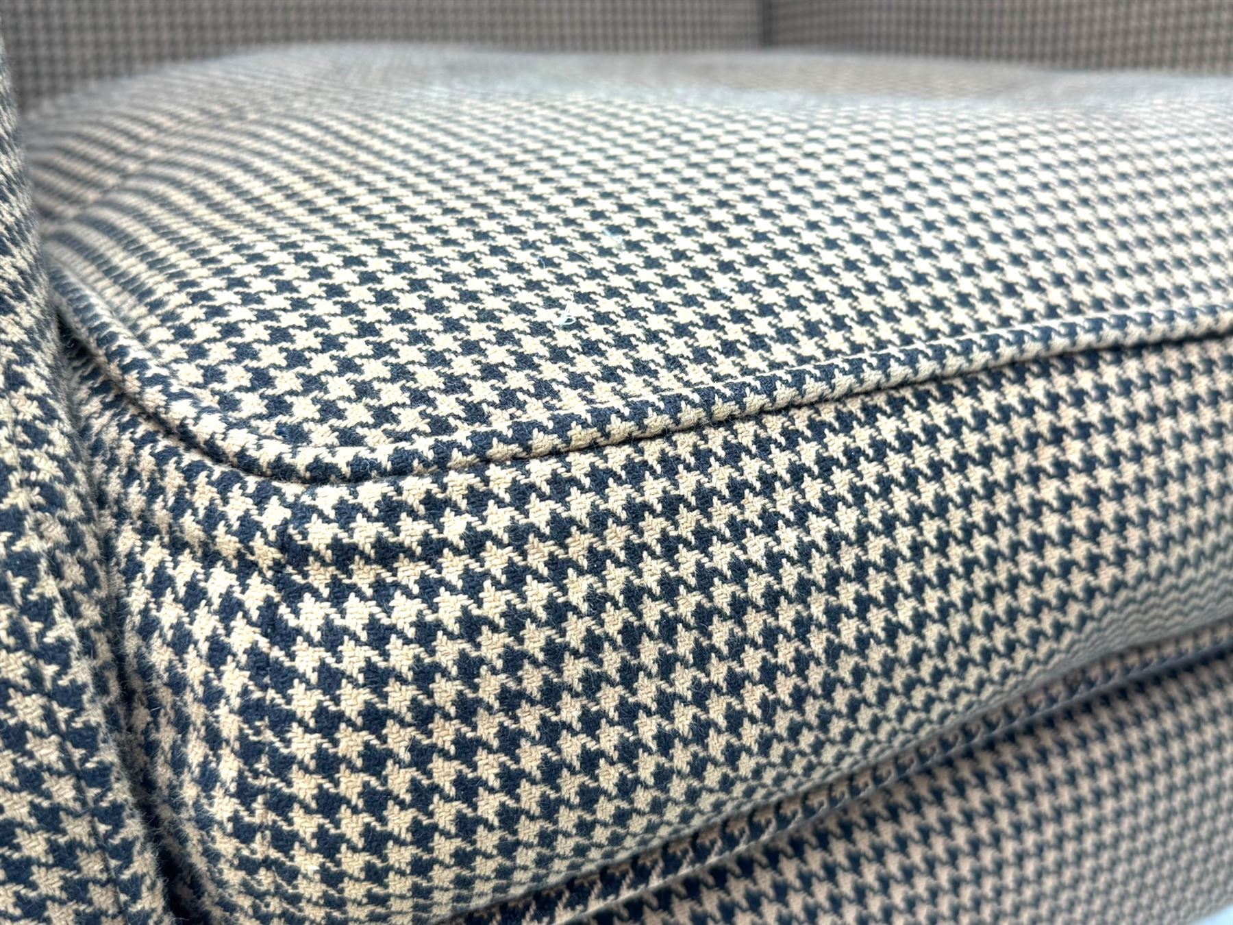 Hardwood-framed wingback armchair, upholstered in dog tooth pattern fabric, on cabriole supports 