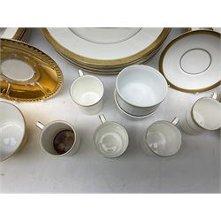Royal Doulton Royal Gold pattern coffee and dinner wares comprising six coffee cans and saucers, eight dinner plates, seven side plates, six dessert plates, and Royal Worcester Gold Lustre tea wares