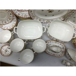 Wedgwood dinner service decorated in the 'Bianca' pattern, to include eight dinner plates, eight bowls, eight side plates, eight twin handled souo bowls, eight soup bowl saucers, eight teacups, eight teacup saucers, six dessert plates and two larger, two twin handled lidded tureens, milk jug, two sauce boats, salt and pepper shakers, oval serving  plate, twin handled sandwich plate, covered sucrier, small rectangular dish and two small circular dishes, all with printed stamp mark beneath