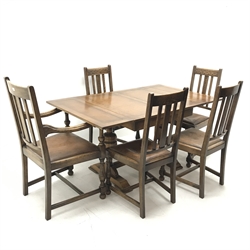 Early 20th century oak drawer leaf dining table, cup and cover supports joined by single stretcher (W150cm, H77cm, D91cm) and set five (4+1) oak chairs, carved cresting rail, upholstered seat, baluster supports (W61cm)