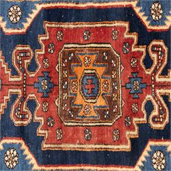 Persian Qashqai rug, wool on cotton foundation, triple stepped lozenge medallions with stylised motifs on a blue ground, within floral and geometric borders in rich red and cream

