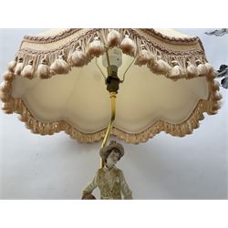 A Belcari figural table lamp, modelled as a young gent leaning upon brick wall, on turned wood base, signed, H70cm incl shade, together with bronzed figural table lamp of a lady with parasol upon ornate circular plinth base, two ceramic table lamps and another lamp (5)