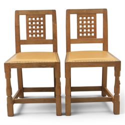 Mouseman - set of four oak lattice back chairs with tan seat with brass studded trim, with carved mouse signature, by the workshop of Robert Thompson of Kilburn