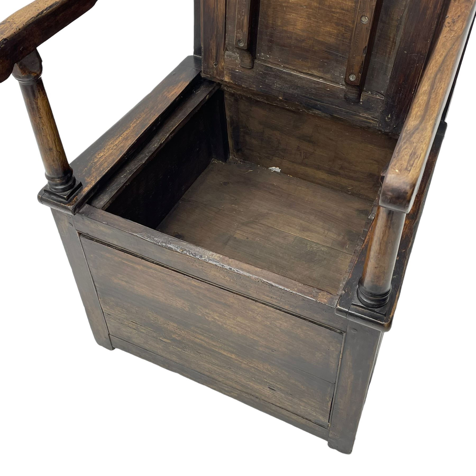 18th century elm box-seat lambing chair, dished cresting rail over panelled back, panelled hinged lid flanked by two turned arm supports