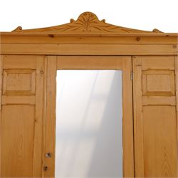 Victorian waxed pine wardrobe, carved projecting cornice with mirrored door, enclosing clothes hooks and rail, above a single drawer with glass knobs