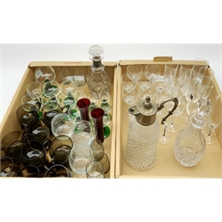 A quantity of assorted glassware, to include a claret jug with silver plated mount, two decanters, a set of six green stemmed German hock glasses, six smaller, eighteen smoky glass cups, plus a number of crystal and other drinking glasses. 