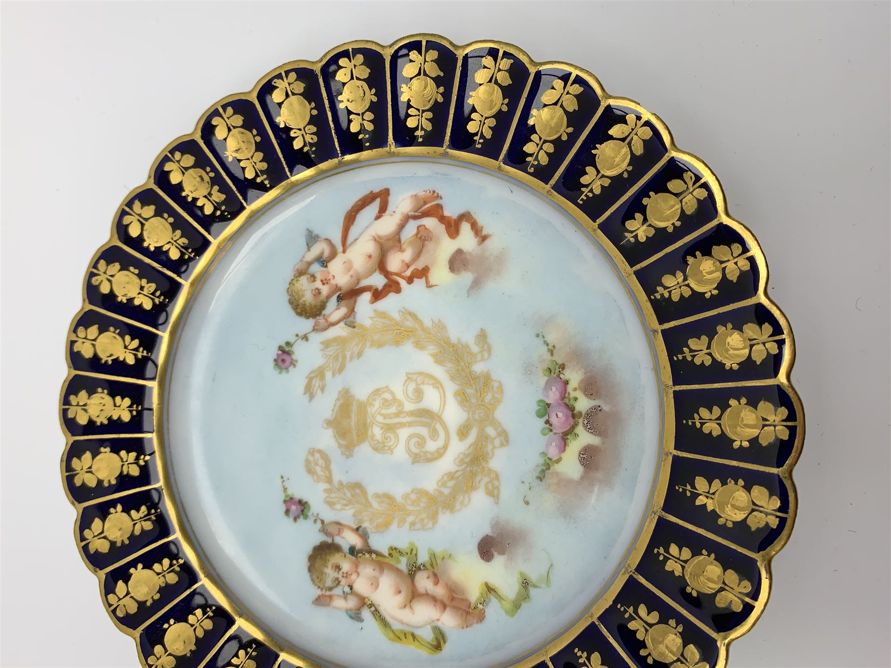 Mid 19th century Sevres Louis Philippe period porcelain cabinet plate, decorated with central Louis Philippe crowned monogram flanked by two cherubs, within cobalt gilt detailed border, with date mark for 1846, red inventory mark for Chateau des Tuileries, and blue monogram mark , D14.5cm