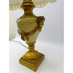  Classical style gilded baluster table lamp with cherub masks on moulded square base with fringed shade, H84cm overall   