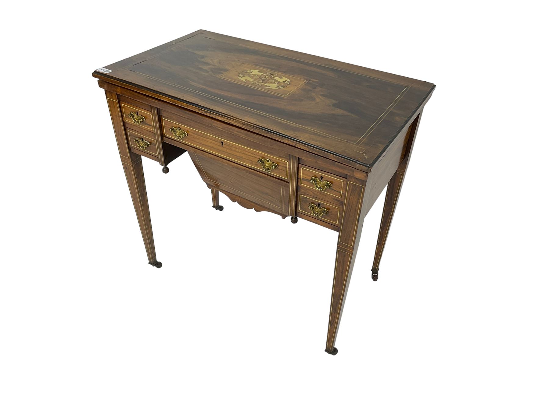 Edwardian inlaid mahogany games or work table, rectangular fold-over top inlaid with stylised dragon ivorine decoration and stringing, fitted with one long flanked by four small drawers over sewing compartment drawer, raised on square tapering supports with castors