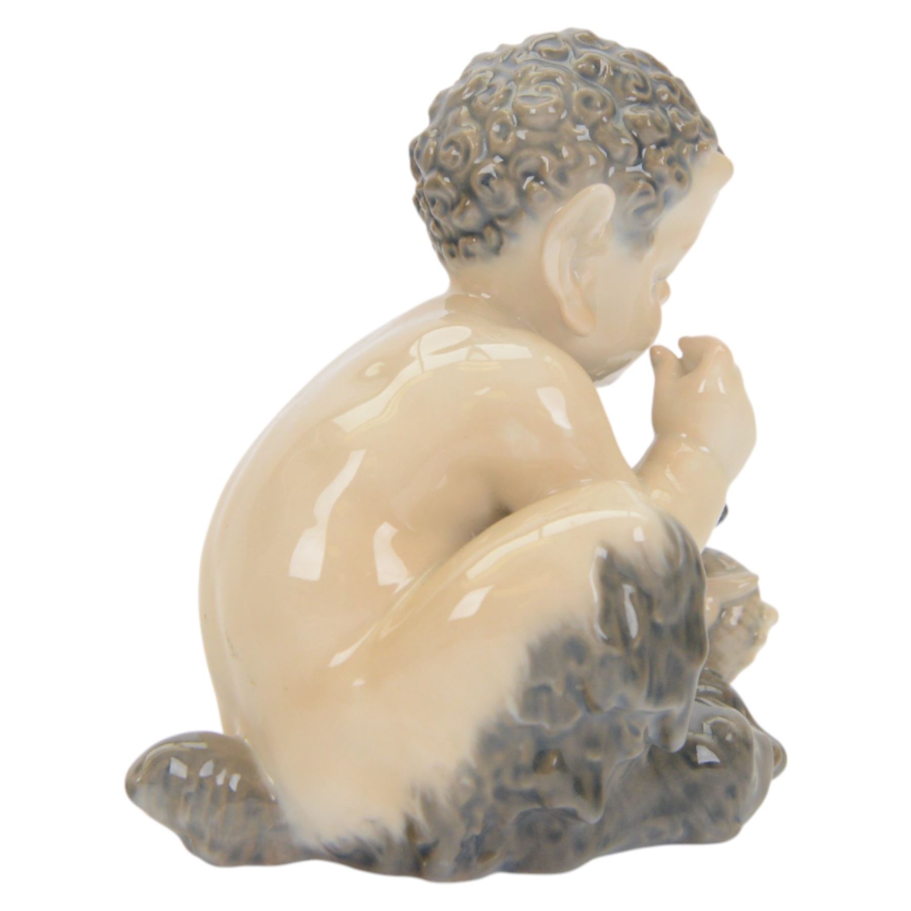 Two Royal Copenhagen figures comprising Faun with Snake no. 1712 and Faun with Bear no. 648