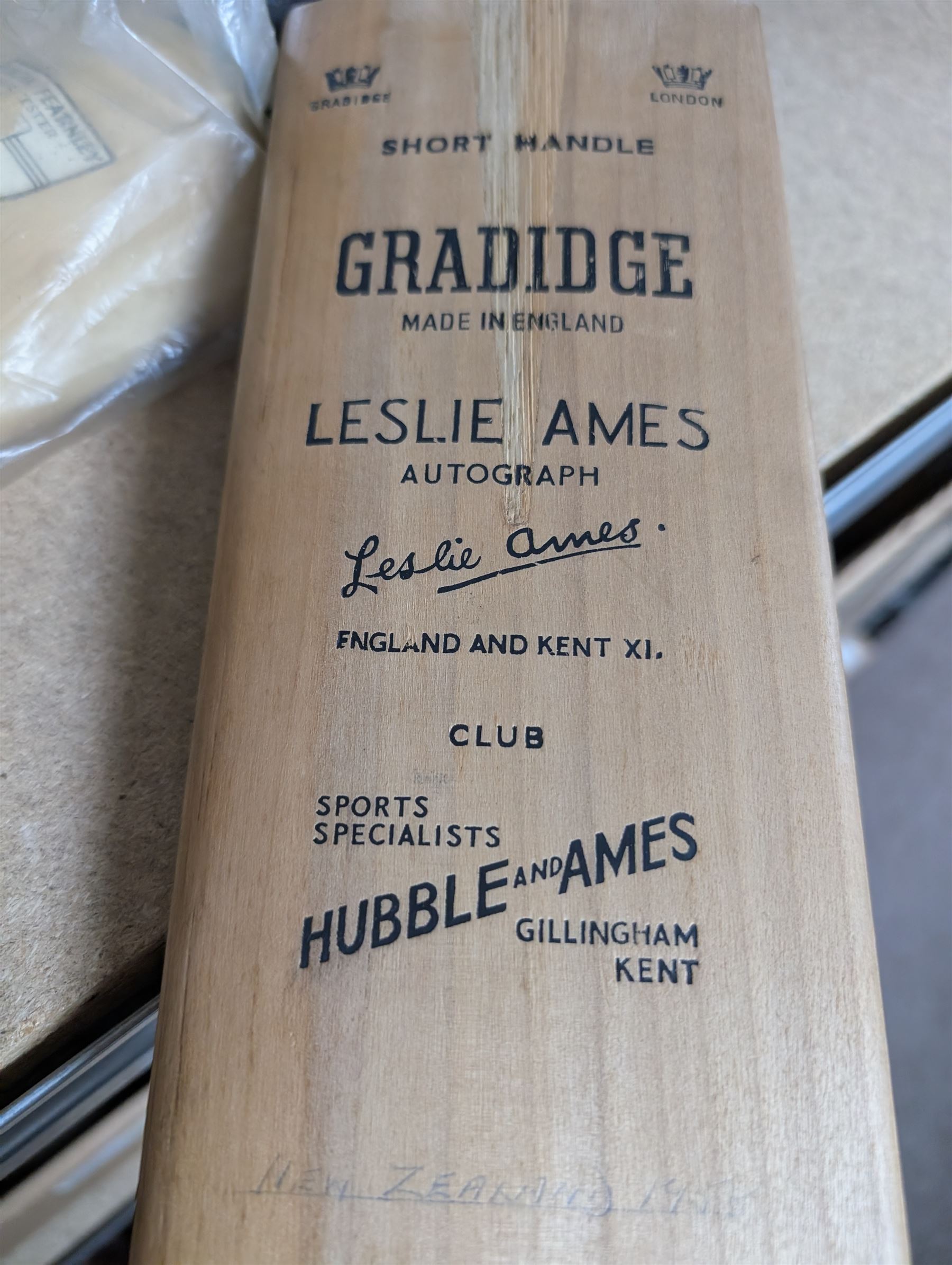 Two signed cricket bats, with signatures including Colin Cowdrey