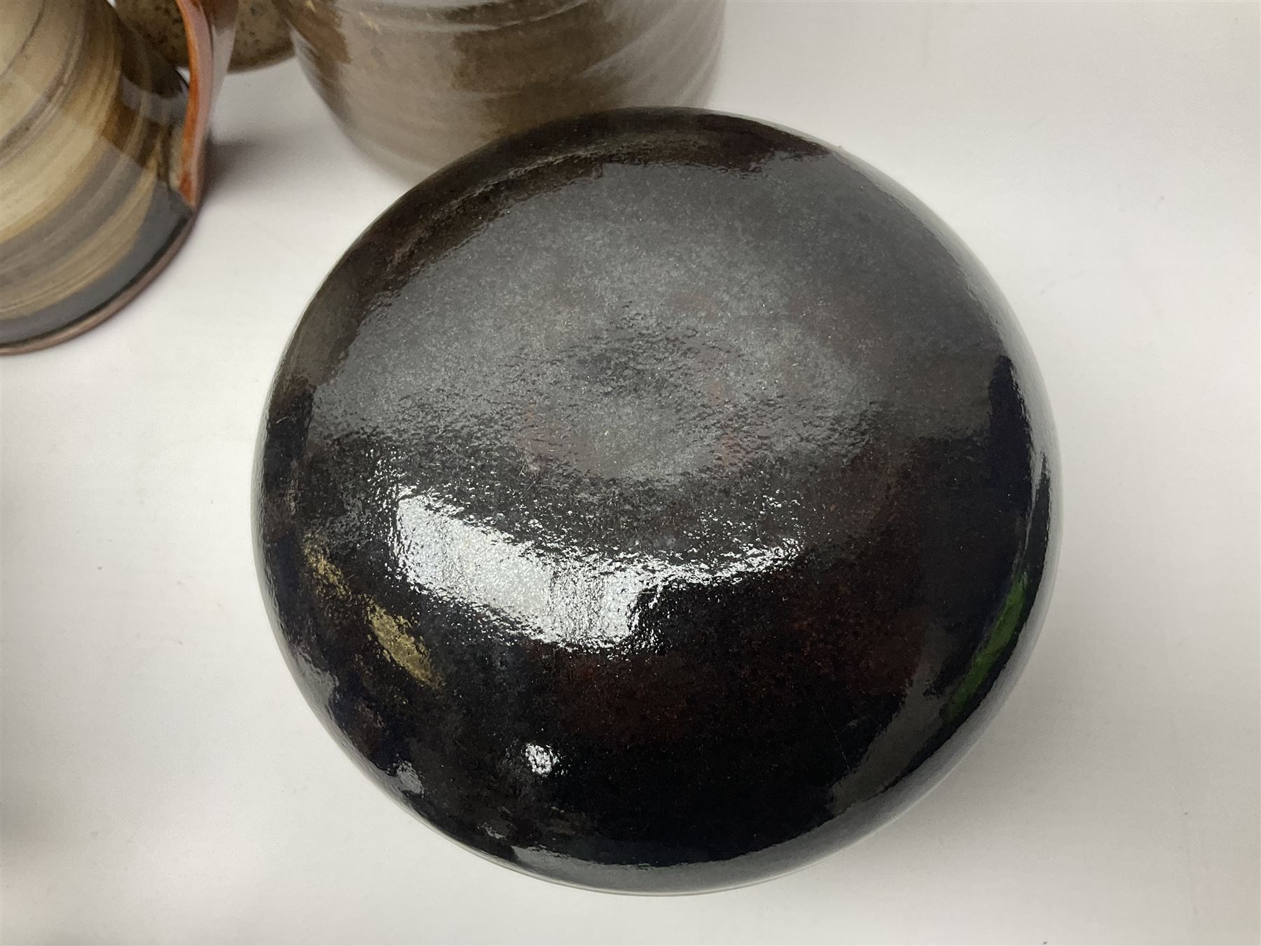 Wold studio pottery tankards, in various colours and relief decoration together with other studio items including vases, jugs and pots 