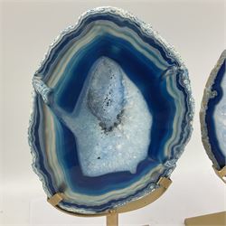 Pair of blue agate slices, polished with rough edges raised upon gilt metal stands, H22cm