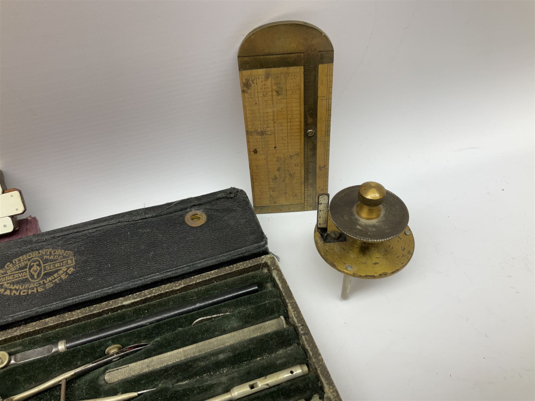 Two Victorian brass sovereign scales, one marked 'Harrison' L10cm; cased set of drawing instruments by G. Thornton Limited Manchester; Chesterman No.770/1 steel vernier caliper; two boxwood rulers; cased slide rule; brass and boxwood rope/wire gauge etc