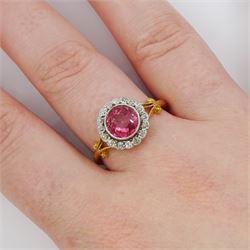 Early 20th century gold tourmaline and diamond cluster ring, milgrain set single stone pink tourmaline of approx 1.35 carat, surrounded by sixteen old cut diamonds, to a split design scroll shank, stamped 18ct, total diamond weight approx 0.30 carat