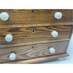 Miniature pine chest, fitted with two short and three long drawers with ceramic handles, H38cm