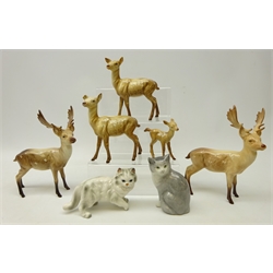  Two Beswick stags, two Doe and a Fawn and two ceramic cats  