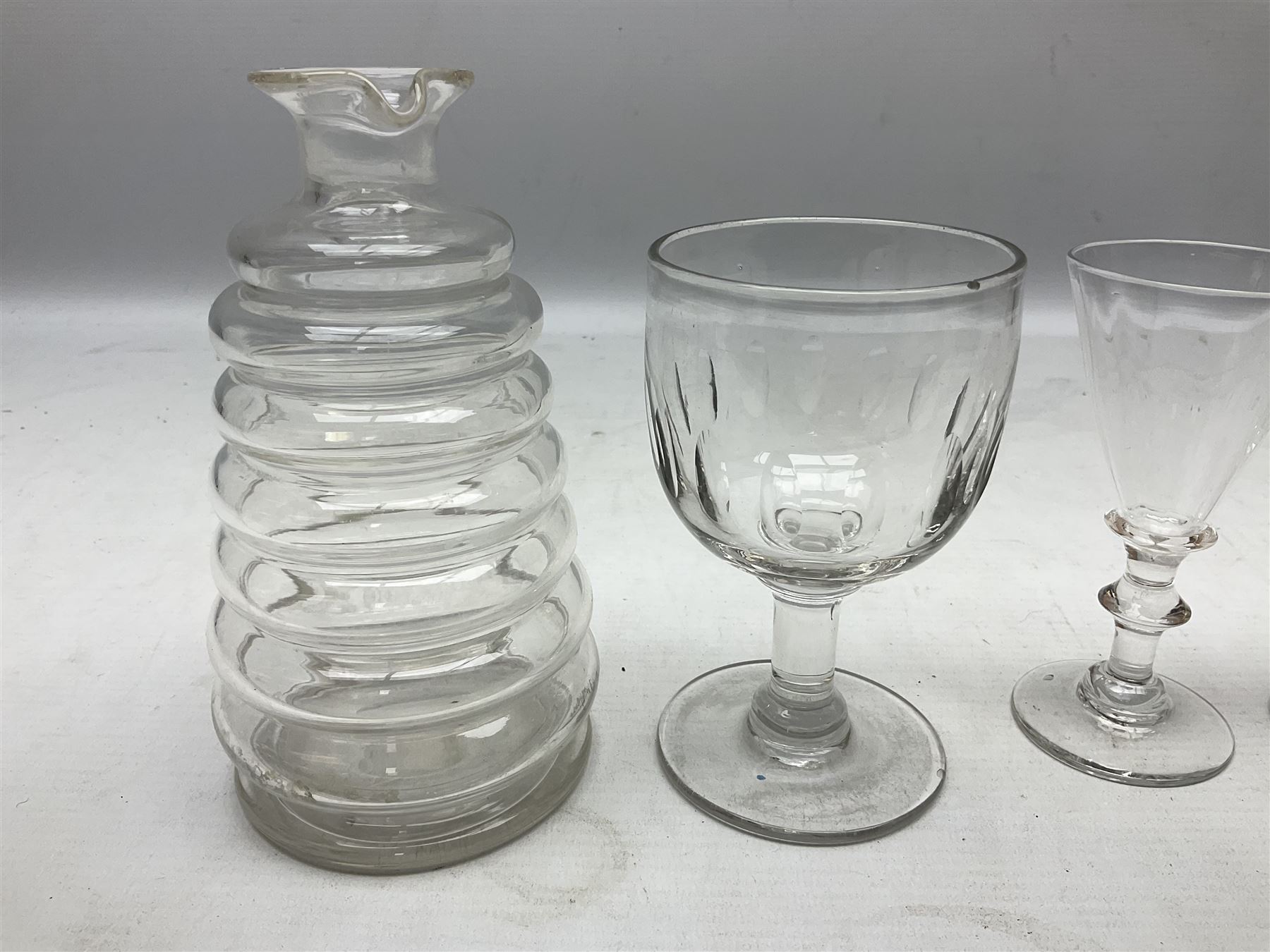 Quantity of Georgian and Victorian glasses, comprising late 19th century Beehive decanter, two thumb print rummer glasses, two 1780s Bristol glass of wrythen form, early Victorian toastmasters glass, two late Georgian wine glasses, late 18th century petal moulded wine glass, and early 19th century facet cut small wine glass